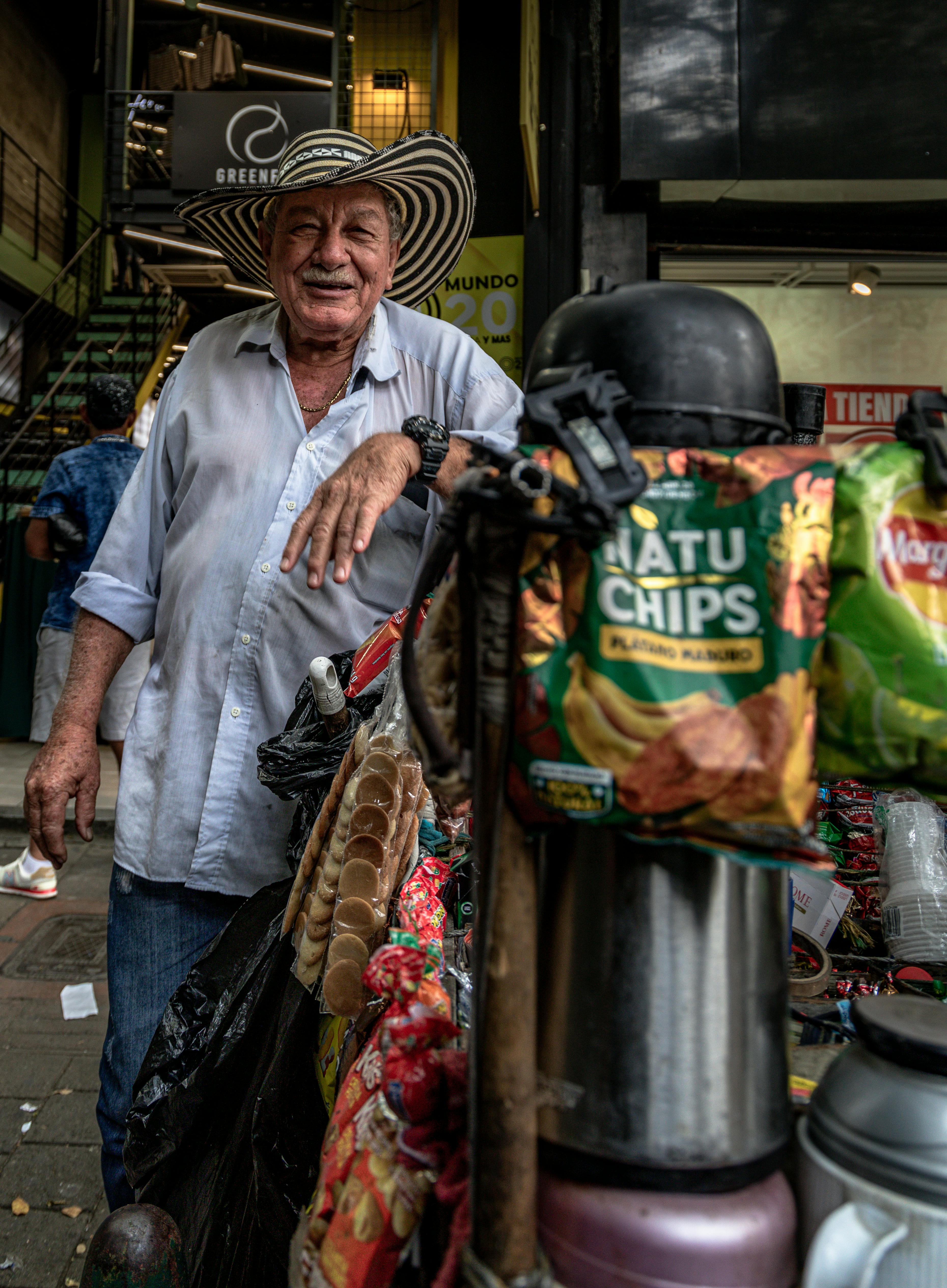 Zadarmo Starší predavač sa usmieva pri stánku s občerstvením a tradičným kolumbijským sombrerom. Fotka z fotobanky