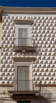 Close-up of a decorative building facade with balconies in Bari, Puglia, Italy.