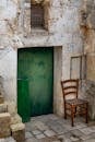 Rustic Italian Doorway with Green Door and Chair