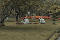 Workers Tending Garden in Lush Park Setting