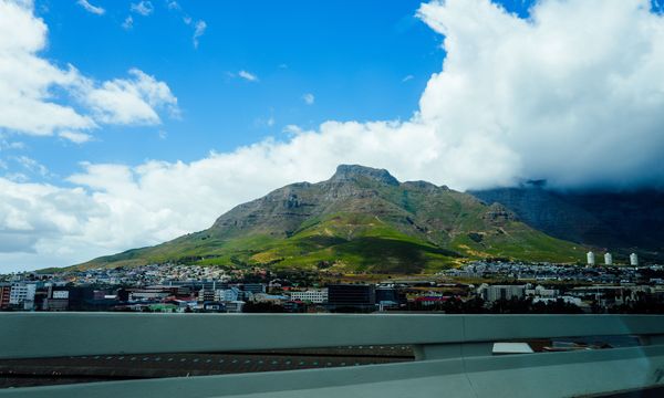 Stunning landscape of Cape Town's iconic Table Mountain under a bright blue sky.