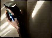 Handwriting in Notebook with Dramatic Lighting