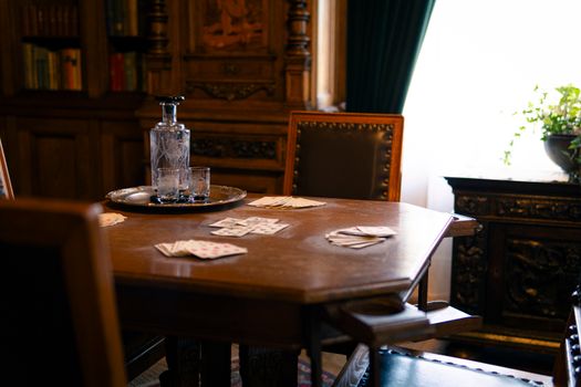 Charming vintage interior featuring a card game setup with crystal decanter, ideal for poker nights.
