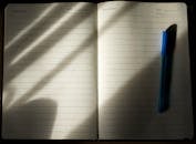 Open Notebook with Pen in Natural Light