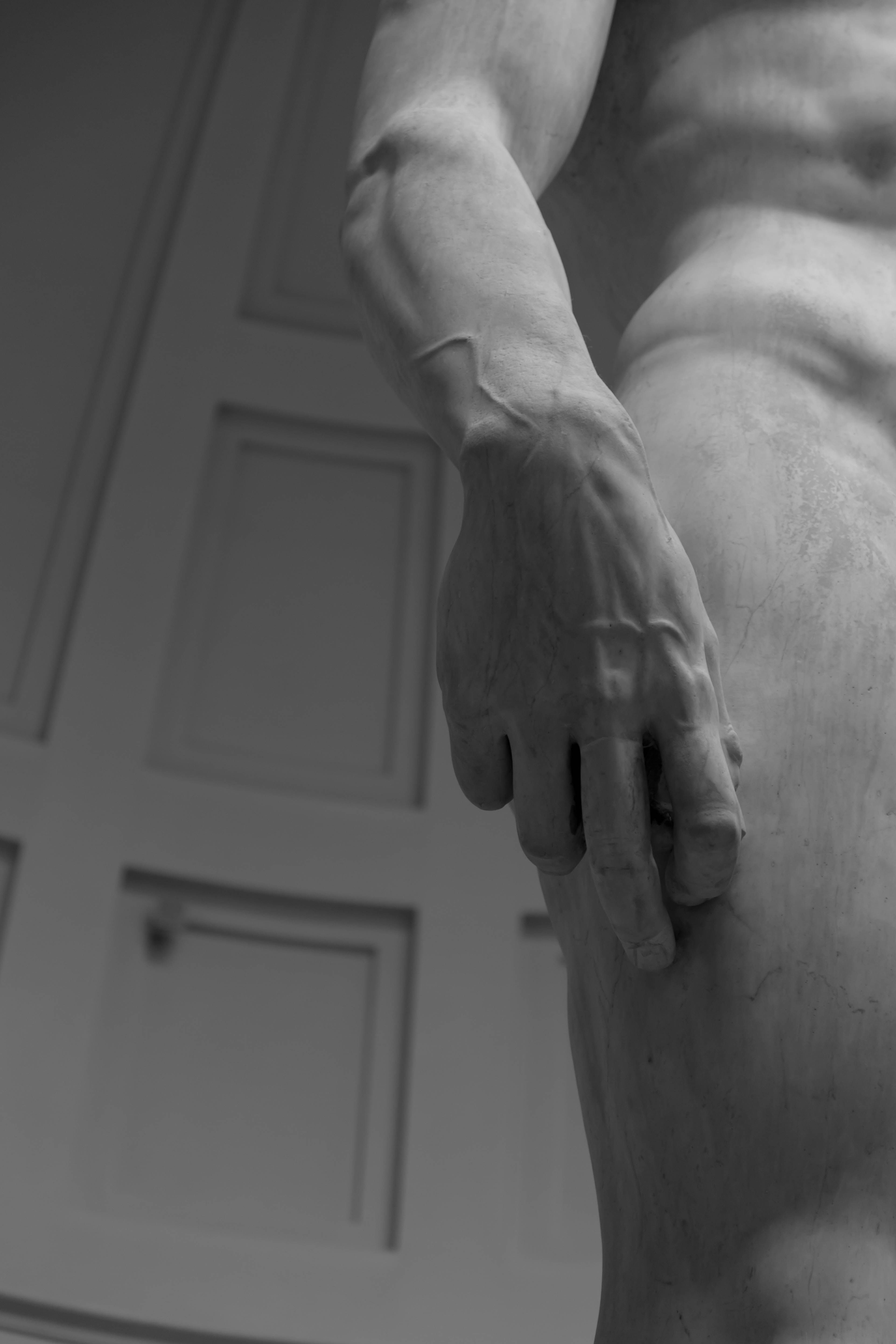 Close-up of Michelangelo's David sculpture emphasizing the intricate details of the hand.