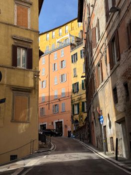 Explore a picturesque street in Perugia with colorful historic buildings and narrow alleys.
