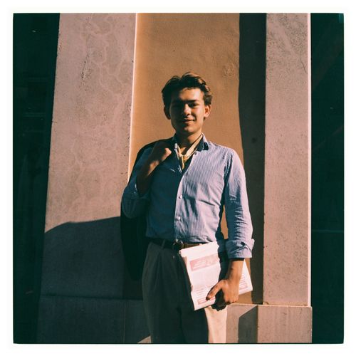 A young man leaning against a sunlit wall — photo by Efe Ersoy on Pexels
