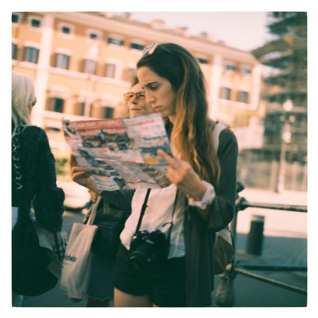 Casual scene of a woman reading a map in the streets of Venice, Italy.