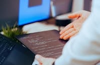 Developer Reviewing Code on Tablet in Office