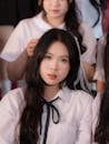 Young Women in Uniform with Long Black Hair
