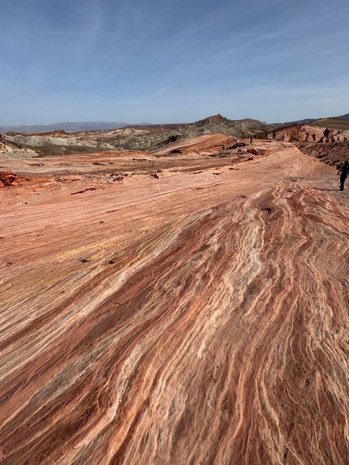 Free Red rock formations stretch under a clear sky in Moapa Valley, Nevada. Stock Photo