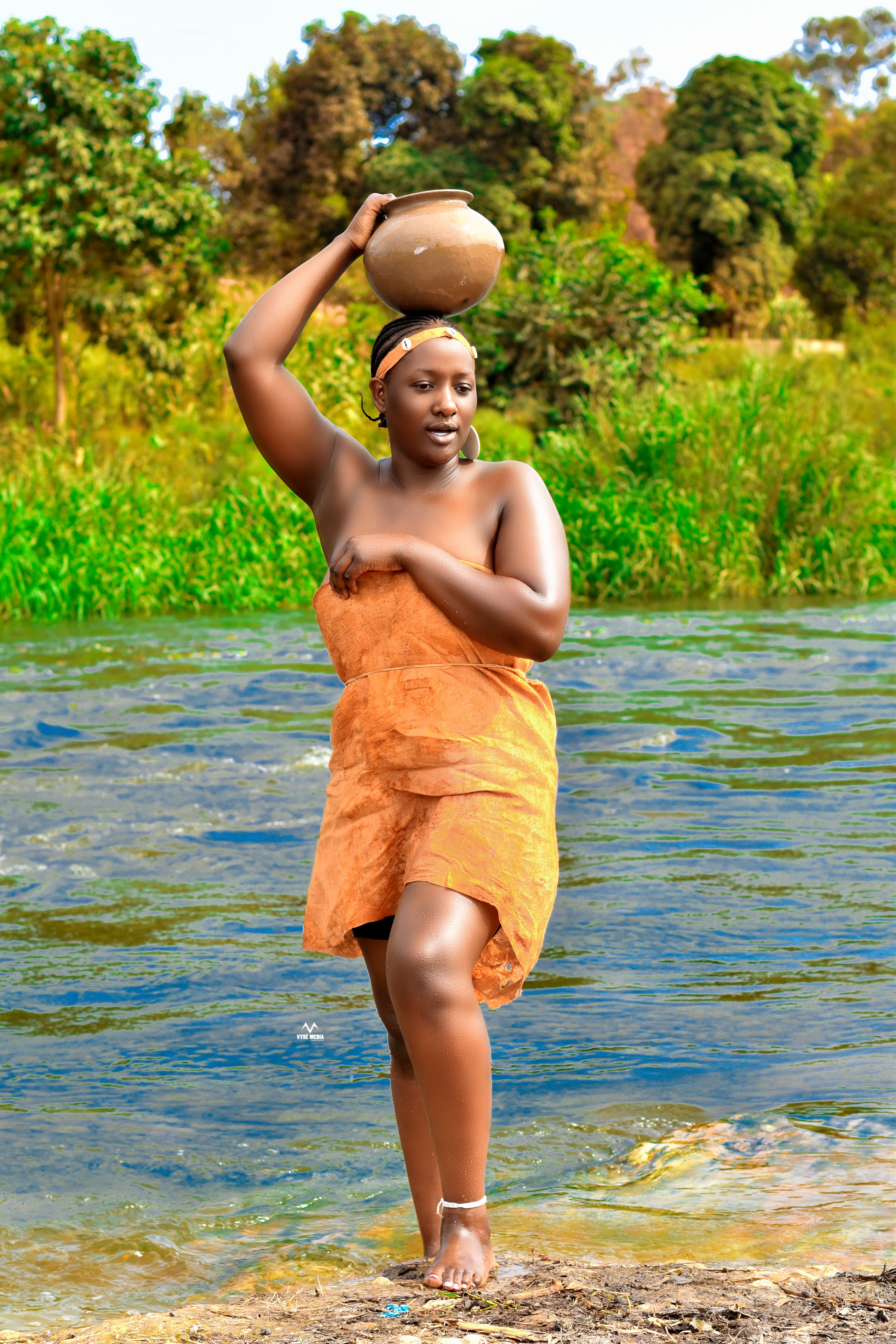 Traditional African Woman by River with Pot · Free Stock Photo