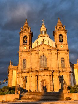 The stunning Bom Jesus do Monte Sanctuary in Braga, Portugal, illuminated at sunset.