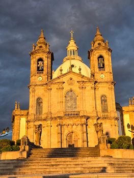Golden hour view of the Bom Jesus do Monte Sanctuary in Braga, Portugal, with dramatic skies.