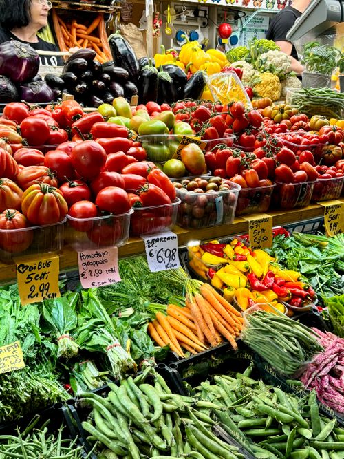 Free Fresh vegetables and fruits at an Italian market stall in Bologna, capturing the essence of local produce. Stock Photo