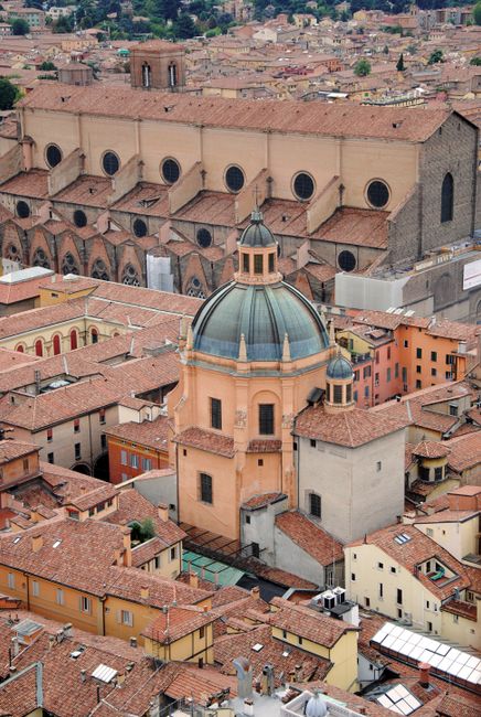 Captured from above, this image showcases the iconic red-tiled roofs and historic architecture of Bologna, Italy.