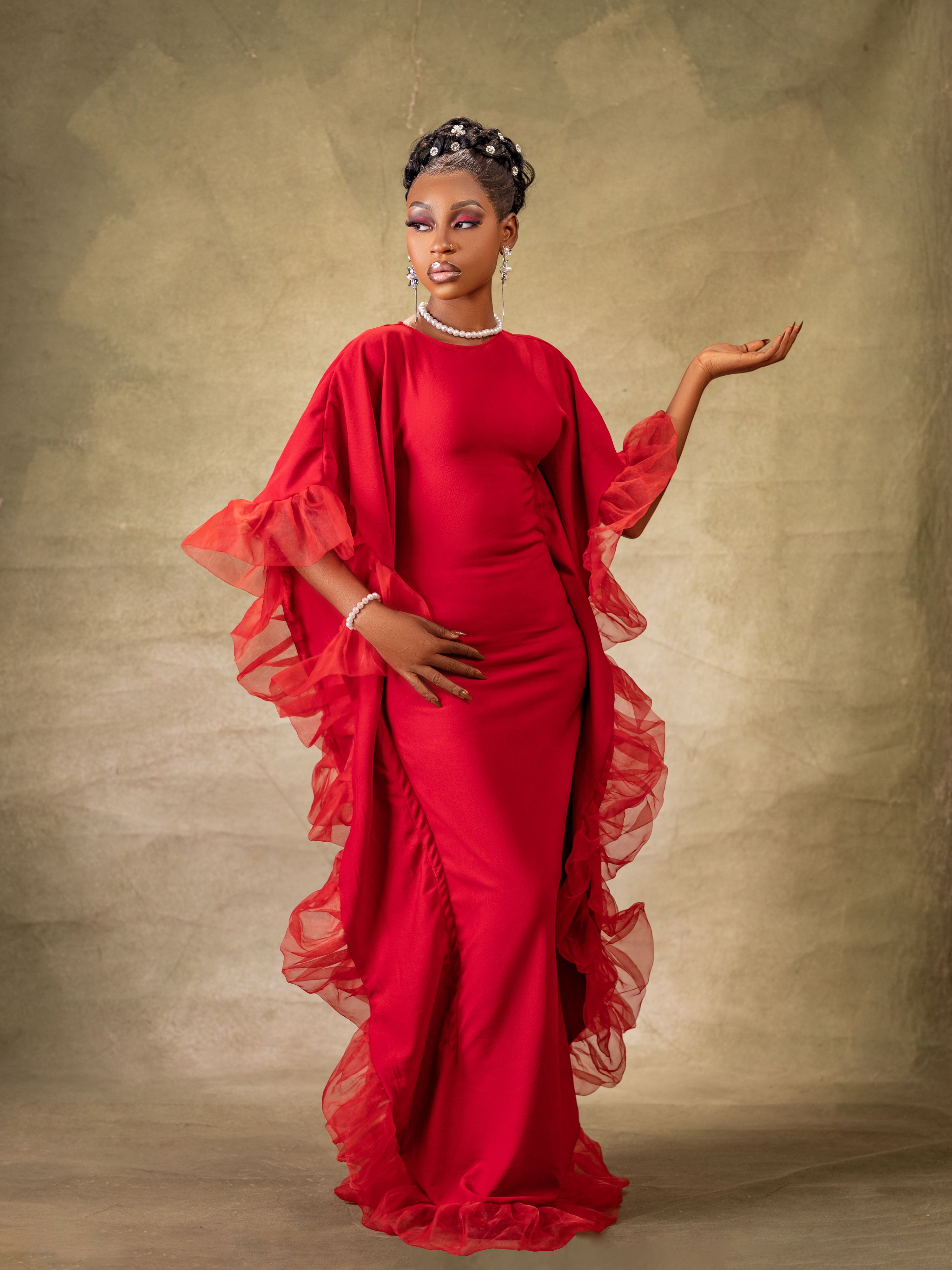Elegant Woman in Red Dress with Dramatic Pose