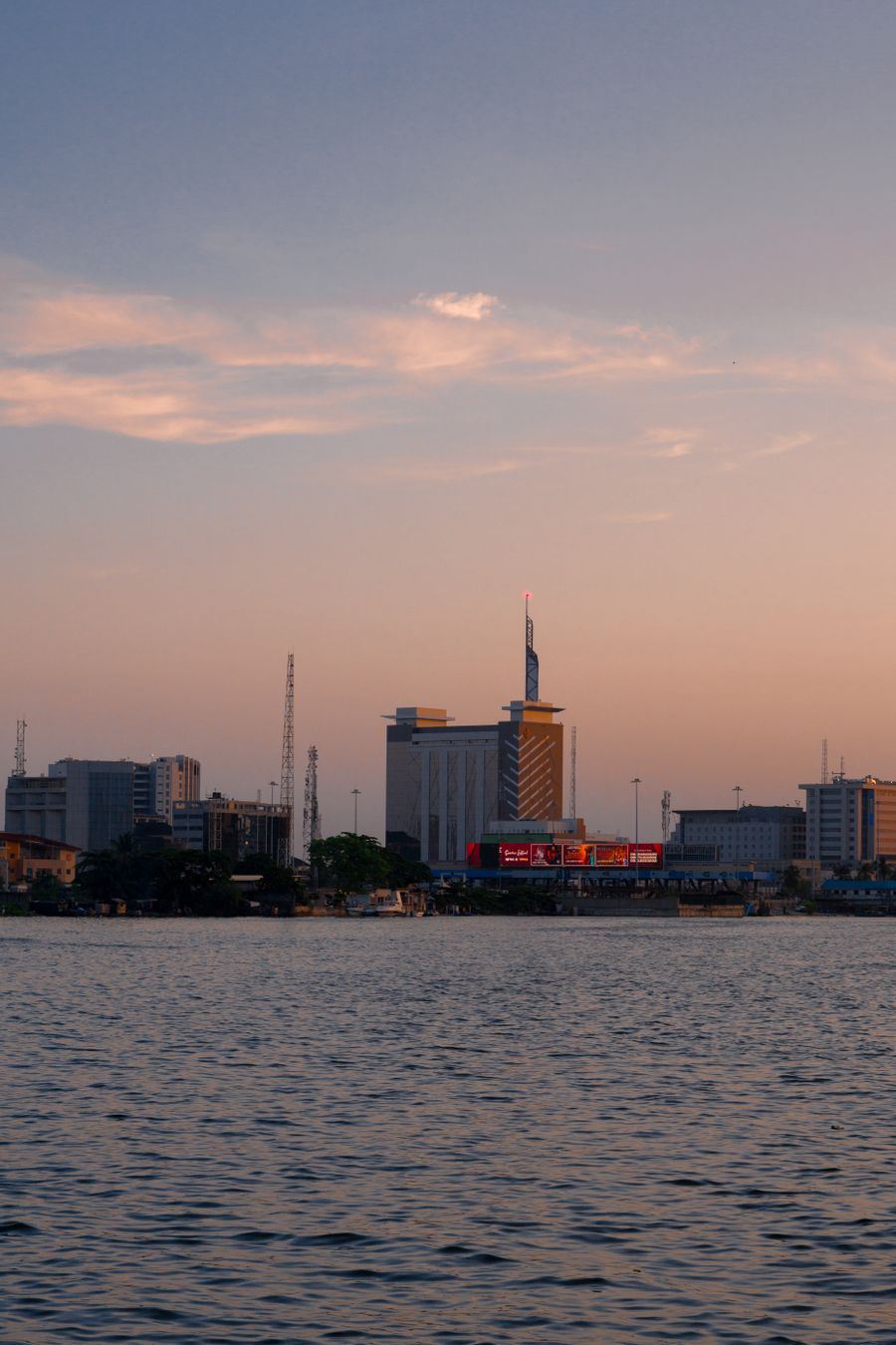 The Lagos skyline at sunset, reflected in the lagoon