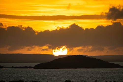 Silhouette of Dune Against Sunset