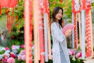 Asian Woman Holding Fan at Outdoor Festival