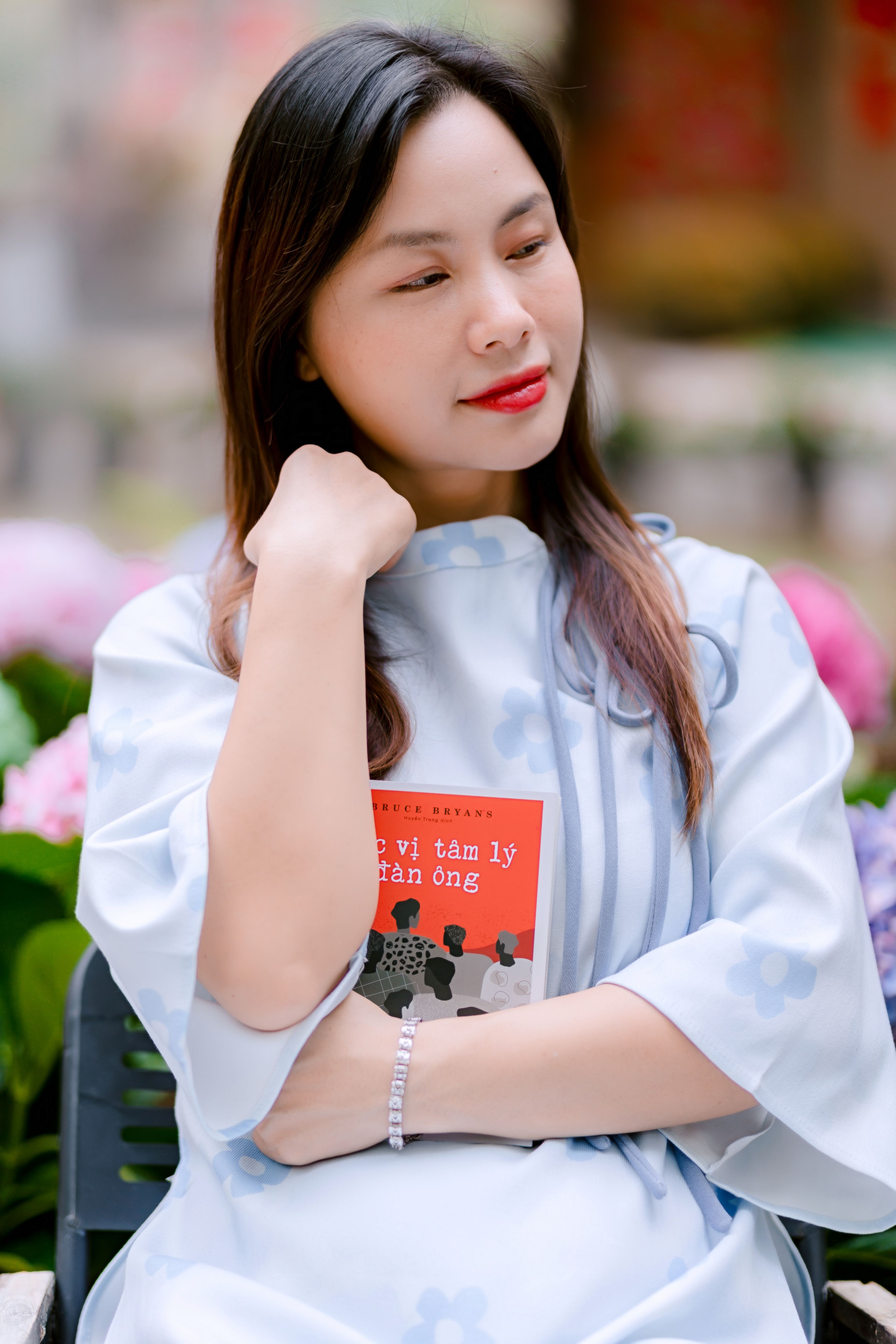 Portrait of Woman Holding a Book in Garden Setting
