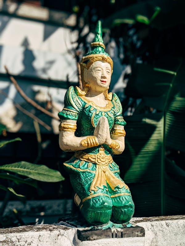 Green and Brown Ceramic Buddha Figurine