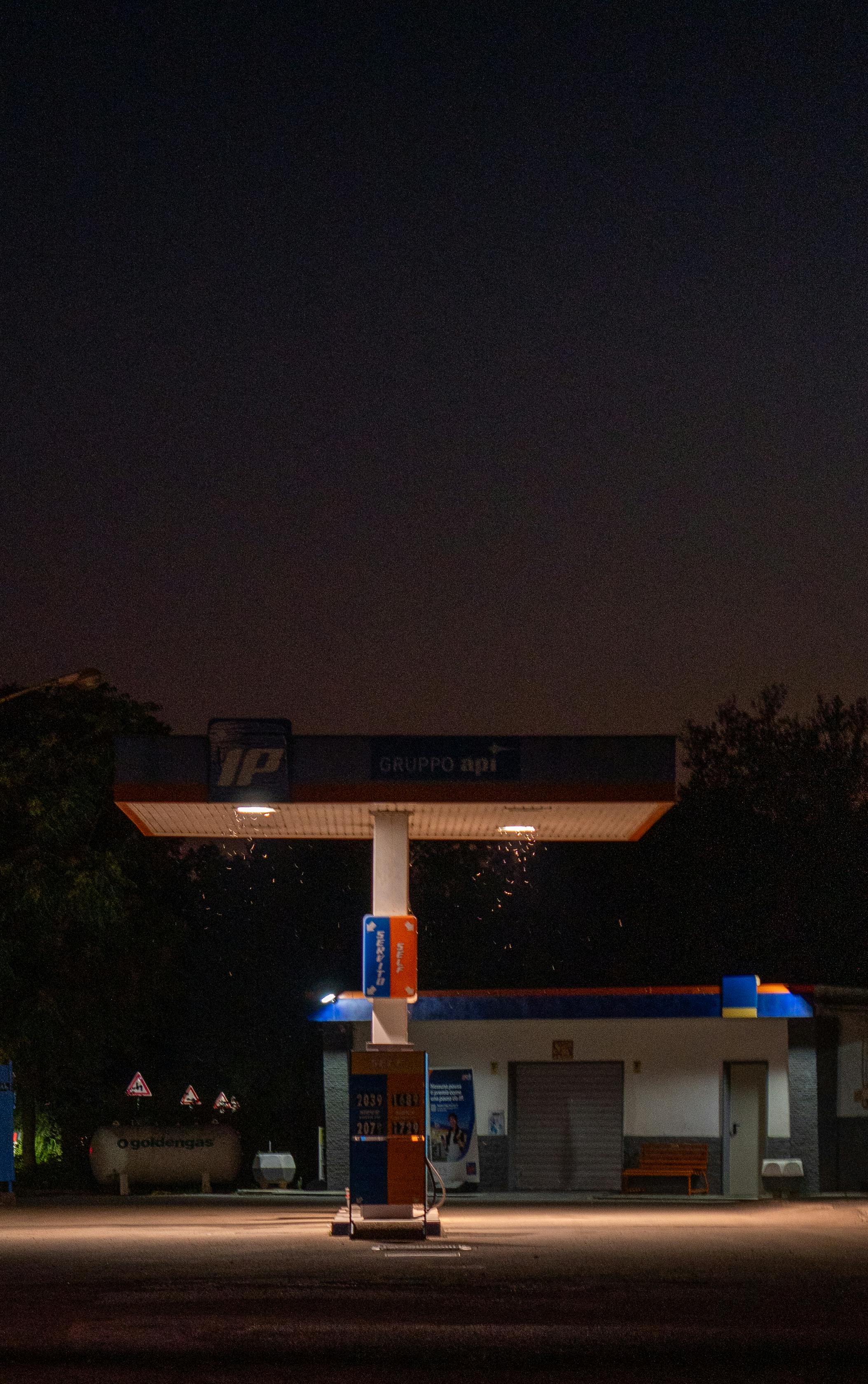 Zadarmo Tichá nočná scéna osvetlenej čerpacej stanice v Taliansku, zachytávajúca pokojnú atmosféru. Fotka z fotobanky