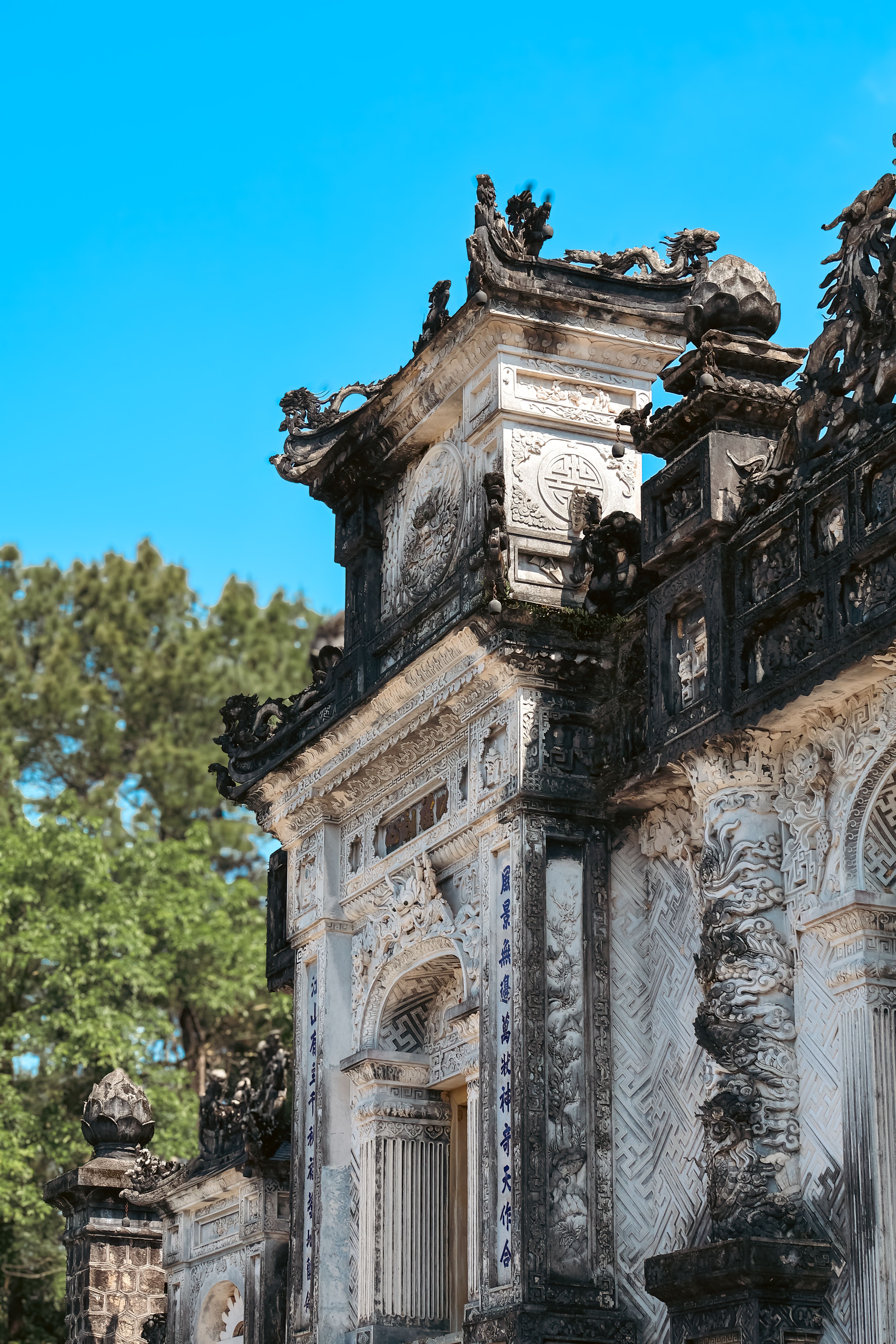 Detailed view of historic architecture in Hue, Vietnam showcasing intricate carvings.