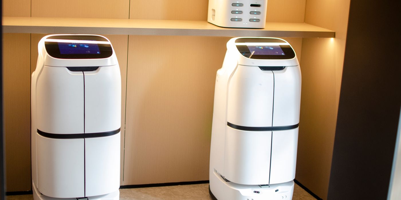 White service delivery robots in a modern hotel interior