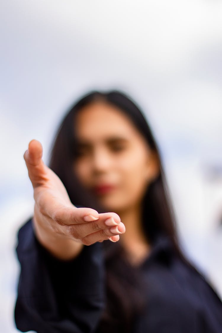 Young Ethnic Woman Giving Handshake To Camera