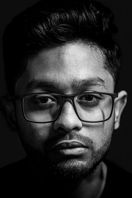Free Striking black and white portrait of a man wearing glasses, conveying focus. Stock Photo