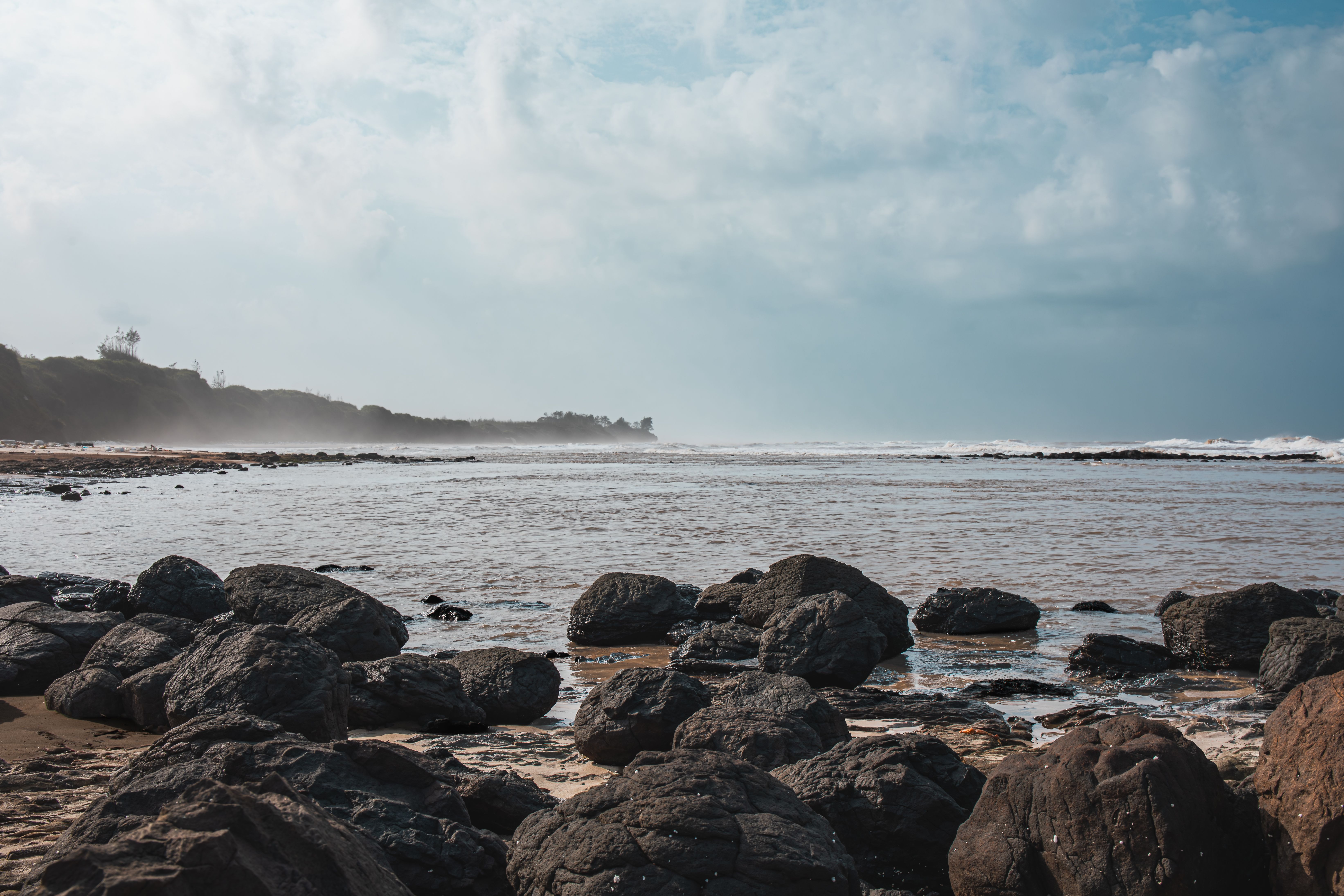 Rocky Beach Landscape under Cloudy Sky · Free Stock Photo