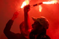 Men Celebrating with Flares at Night