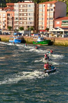 Group enjoying jet skiing on a sunny day in Ribadesella, Spain's vibrant coastal waters.