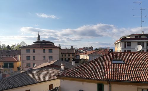 Free Scenic view of Italian rooftops with a distant bell tower under a clear blue sky. Stock Photo