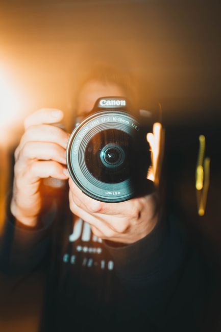 Artistic close-up of a person holding a camera lens in Seattle.