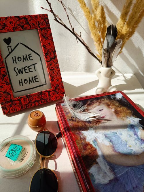 Free A curated selection of home decor items and personal accessories in warm lighting. Stock Photo