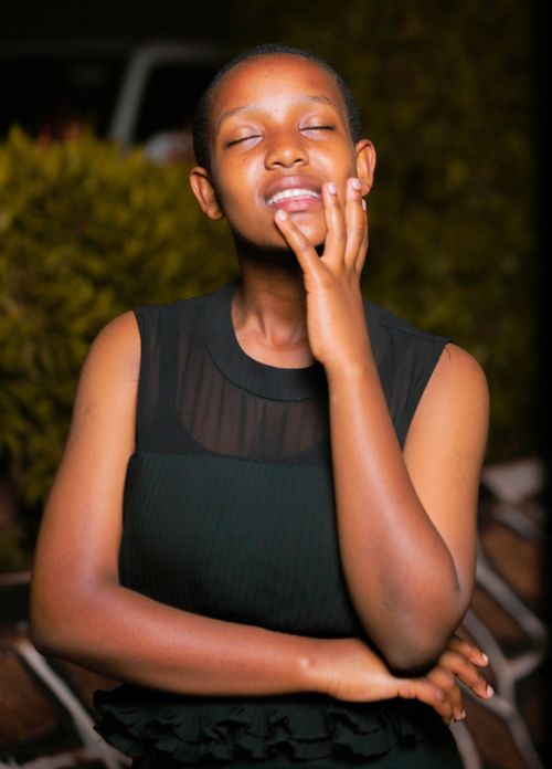 Free Smiling young woman enjoying the moment, captured in an outdoor setting. Stock Photo
