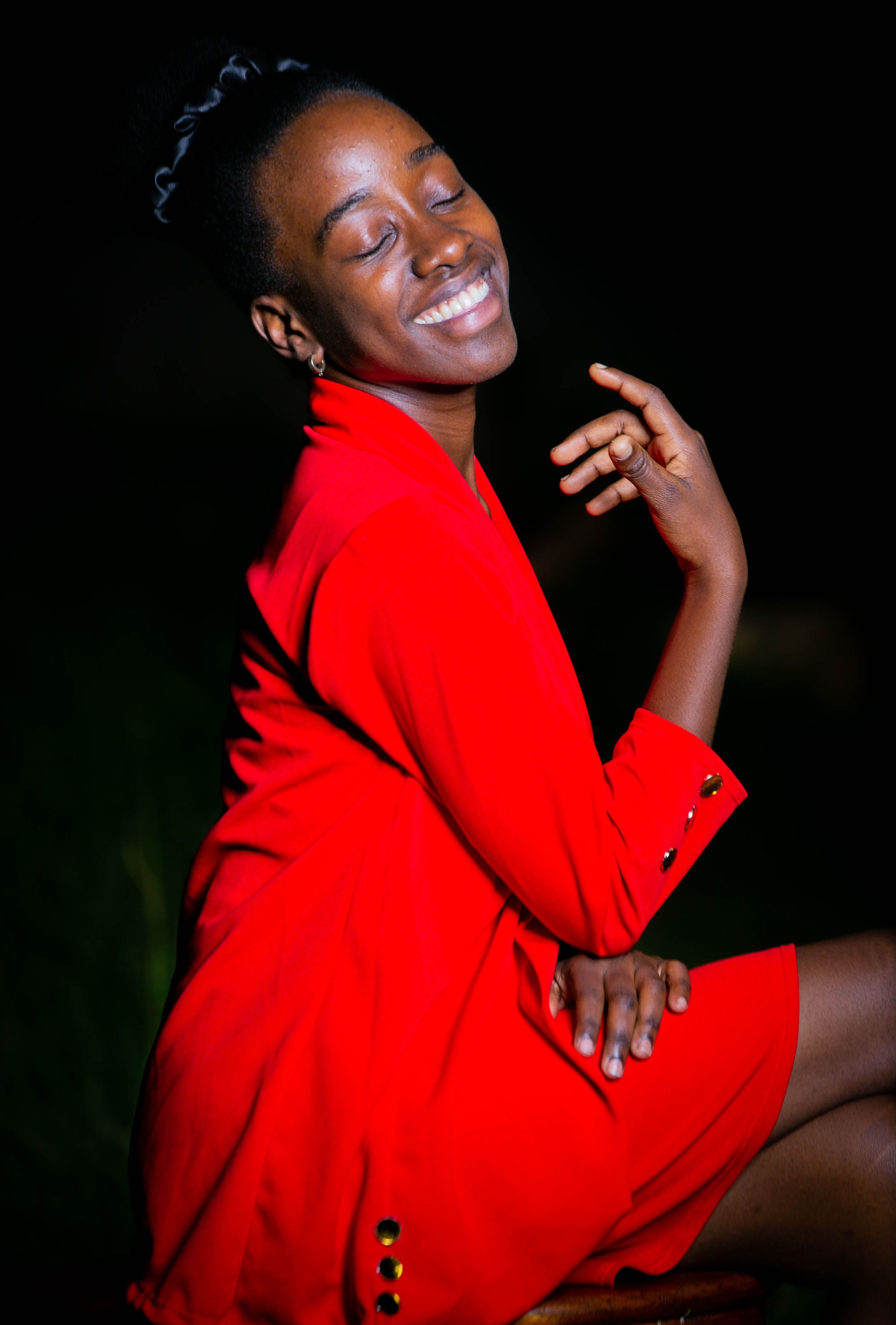 Elegant Woman in Red Outfit Smiling Outdoors · Free Stock Photo