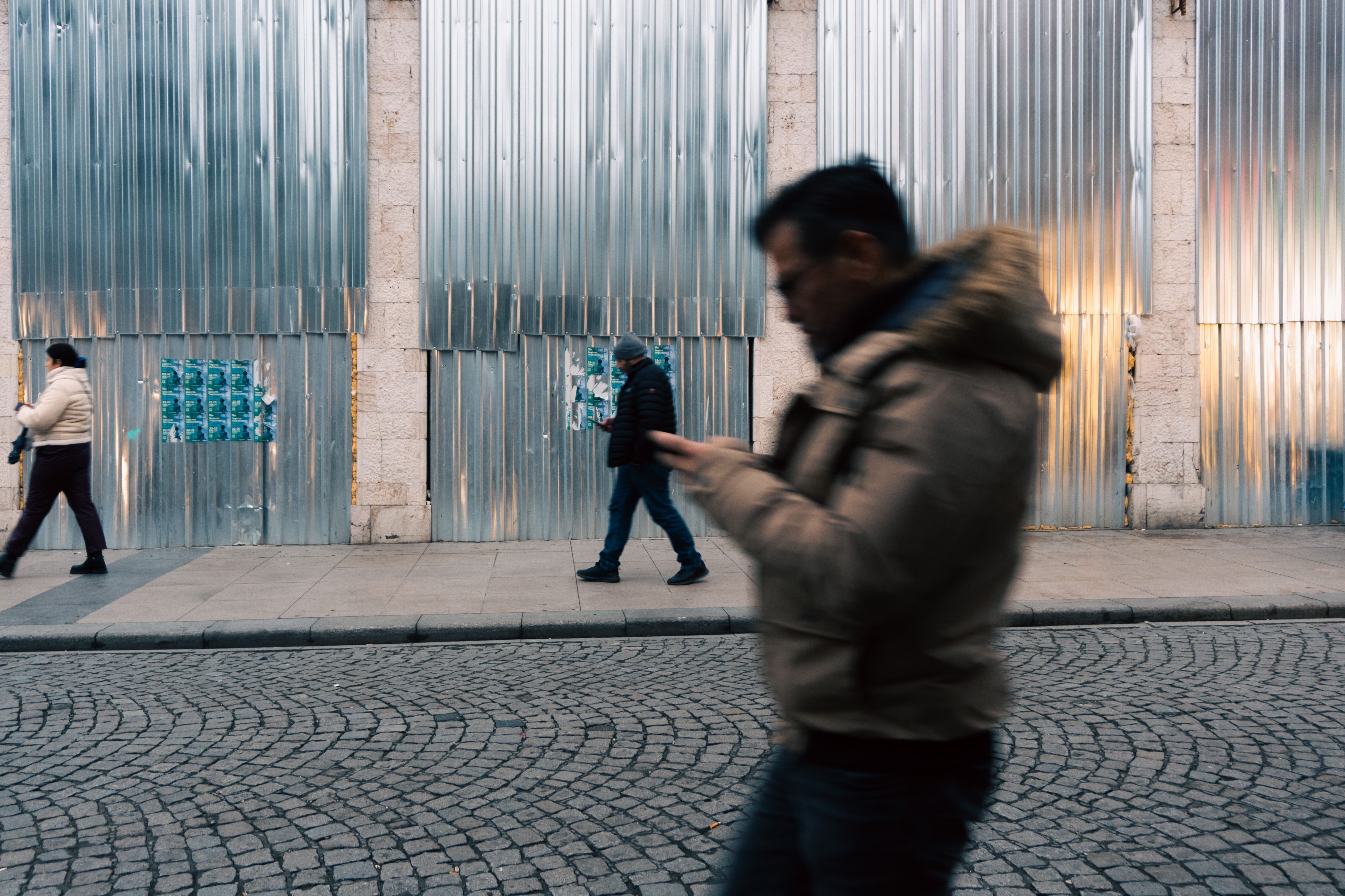 People using smartphones on a bustling street in Belgrade, Serbia