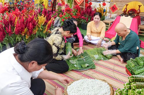 Free Group preparing traditional Banh Tet in a colorful Vietnamese setting. Stock Photo
