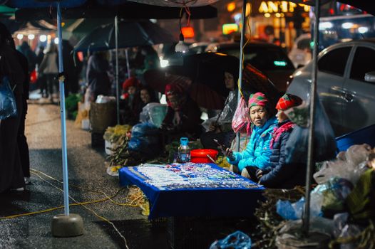 Night market textiles with a weaver — Luang Prabang