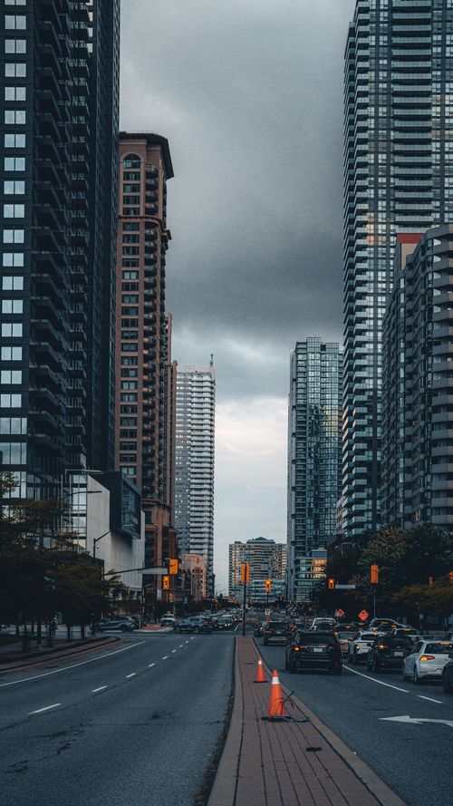 Free A vibrant cityscape of Mississauga, Ontario showcasing modern skyscrapers and bustling traffic under a moody sky. Stock Photo