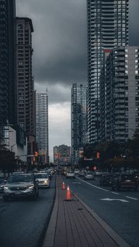 Dramatic view of Mississauga's skyline with high-rise buildings and busy streets under a moody sky.