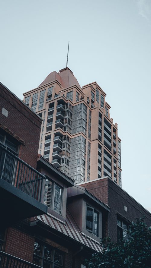 Free A striking modern high-rise building in Mississauga's skyline against a clear sky. Stock Photo