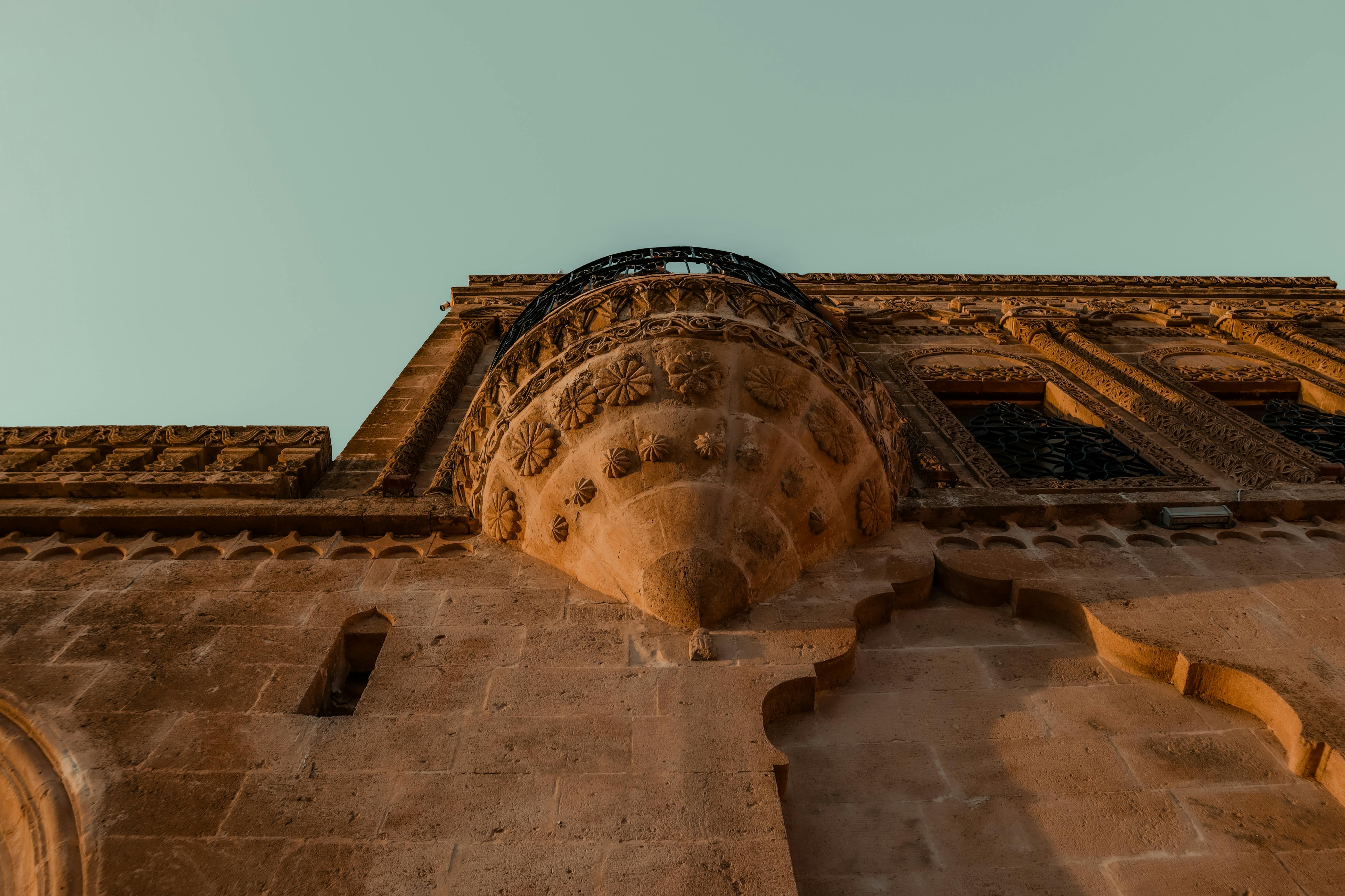 免费 在日落时分，以低角度拍摄了具有精细雕刻的古老石砌建筑。 素材图片