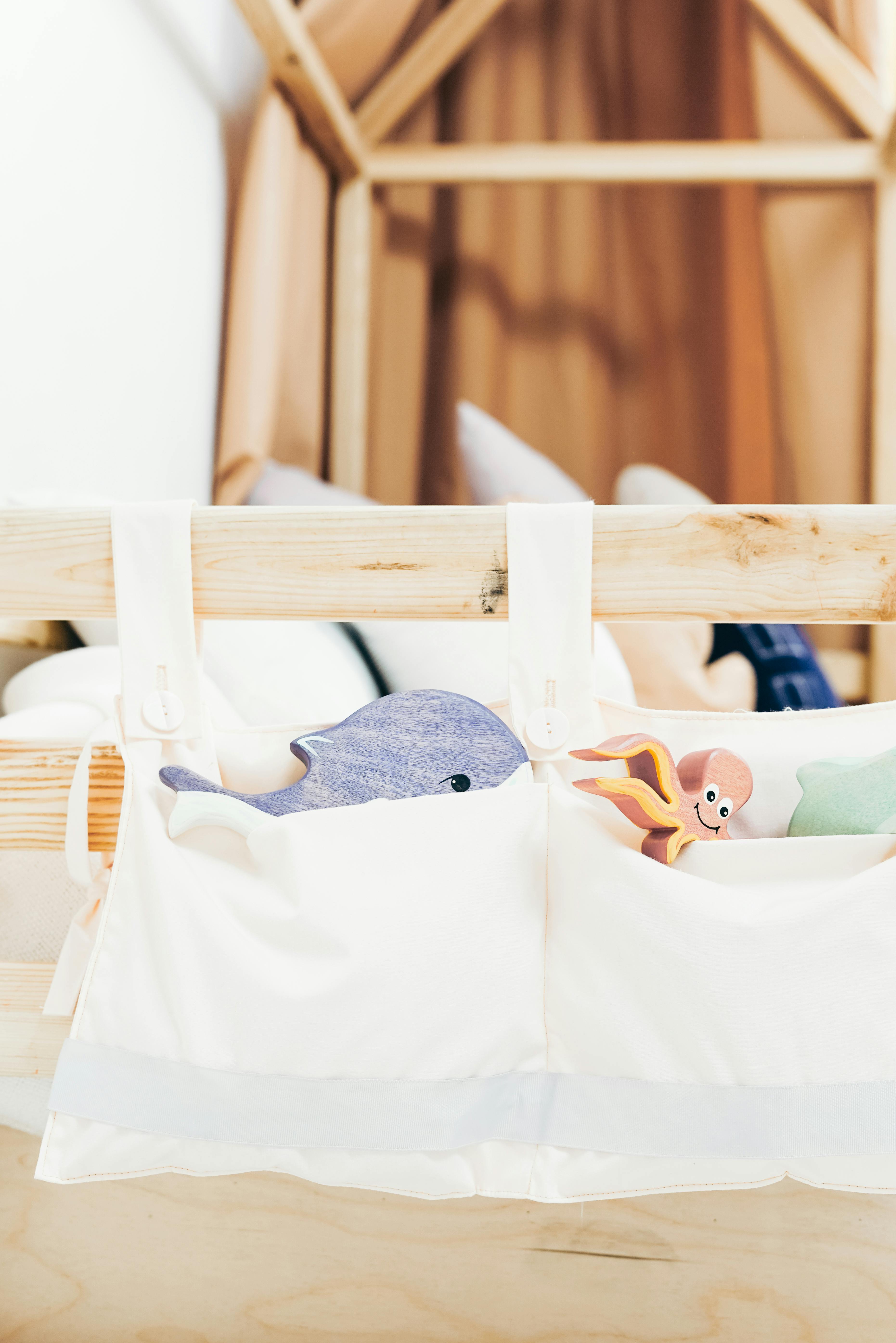 white cloth bag on brown wooden bed