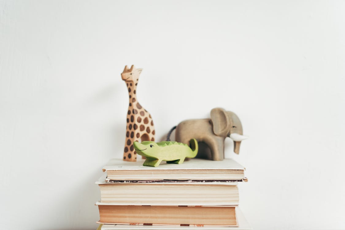 Brown Giraffe Figurine on Books