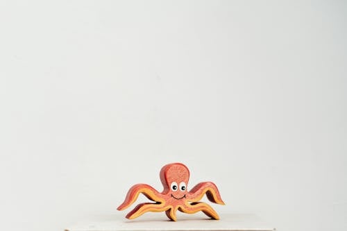 Free Orange Octopus Wooden Toy on White Table Stock Photo