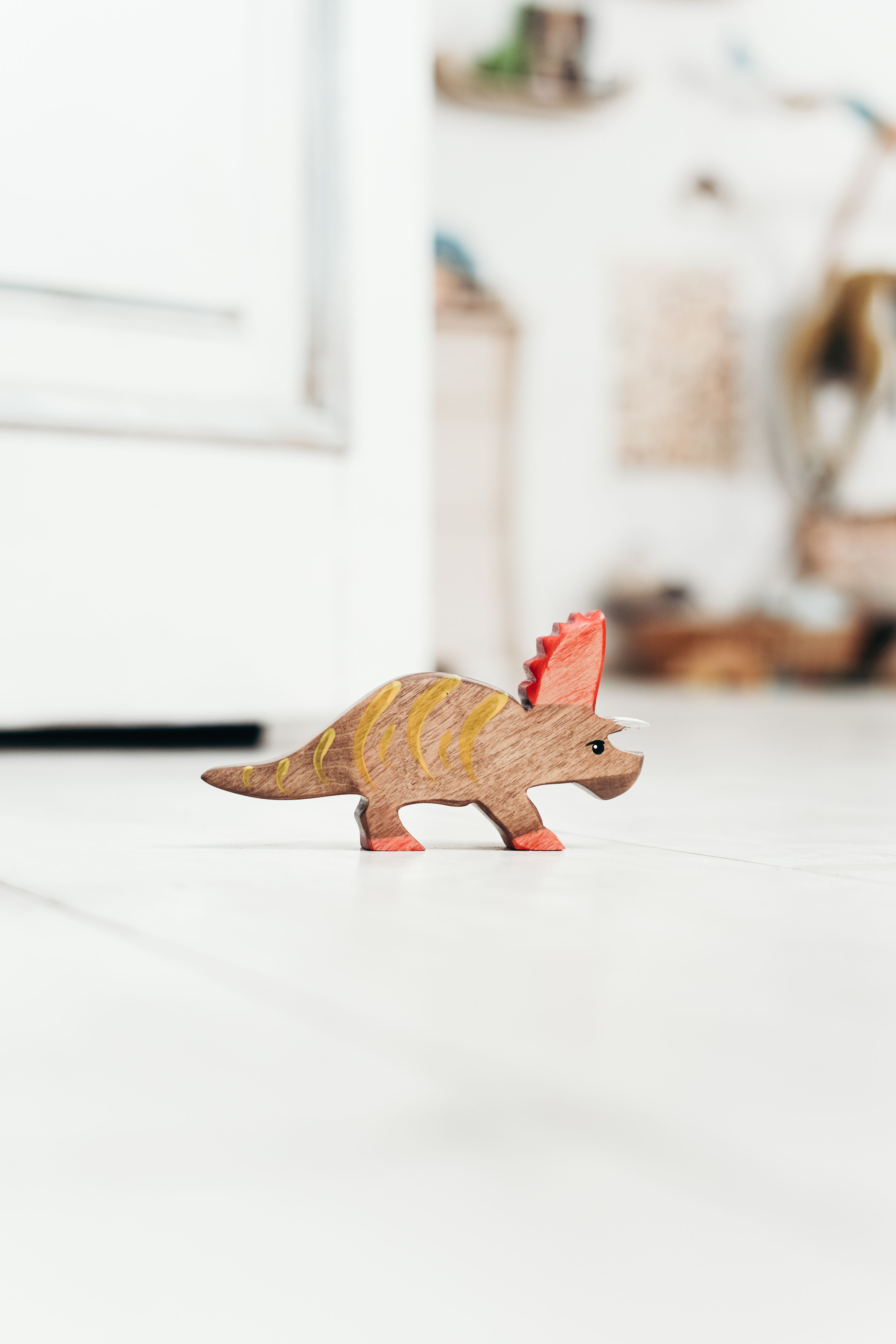 brown-dinosaur-toy-on-white-floor-free-stock-photo